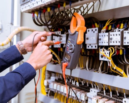 electrician-testing-electric-current-control-panel_34936-2970
