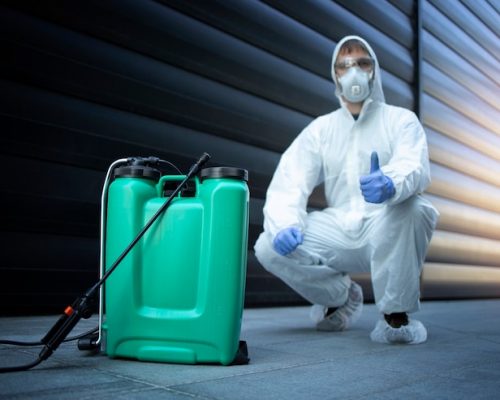 exterminator-white-protective-uniform-standing-by-reservoir-with-chemicals-sprayer_342744-930