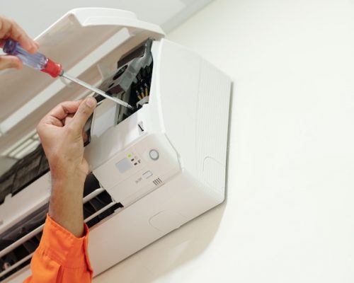 hands-technician-using-screwdriver-when-installing-air-conditioner-bedroom-customer_274689-26051